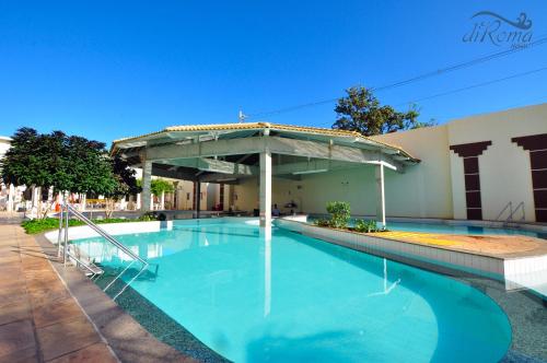 a swimming pool with a pavilion next to a building at diRoma Exclusive com um dia no Acqua Park Splash e Slide in Caldas Novas