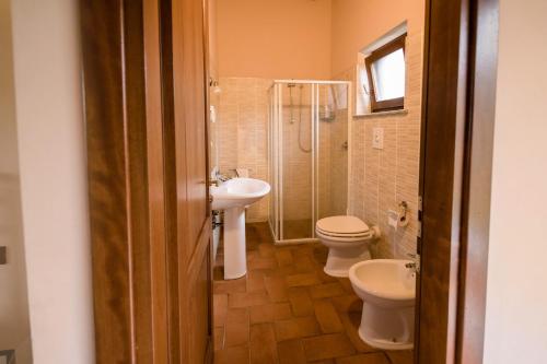 a bathroom with two toilets and a sink and a shower at Agriturismo La Sena in Santa Caterina Dello Ionio Marina