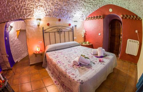 a bedroom with a large bed in a room at Casas Cueva Cazorla in Hinojares