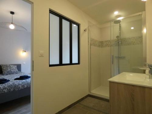 a bathroom with a shower and a sink and a tub at Gîte l'Echappée Belle in Brezolles