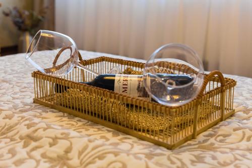 a basket with glasses on top of a table at Grand Lakes Rooms in Plitvička Jezera