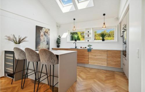 a kitchen with white walls and a skylight at 4 Bedroom Nice Home In Slagelse in Slagelse