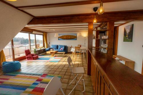 a living room with a couch and a table at Ferienwohnung Weitblick mit Sauna in Daisendorf