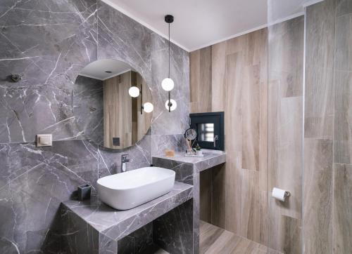 a bathroom with a sink and a mirror at Arbona Apartment Ι in Vóroi