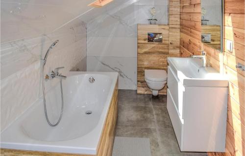 a bathroom with a tub and a sink and a toilet at 3 Bedroom Cozy Home In Majdy in Majdy