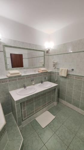 a bathroom with two sinks and a mirror at Smolenický zámok in Smolenice