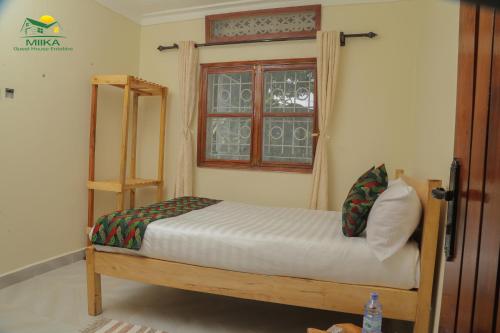מיטה או מיטות בחדר ב-Miika Guest House