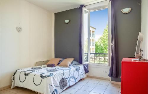 a bedroom with a bed and a window at Stunning Apartment In Marignane With Wifi And 1 Bedrooms in Marignane