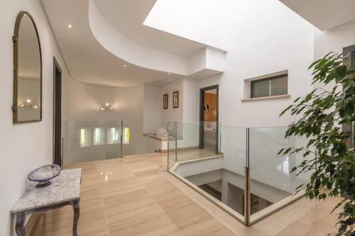 a hallway with a glass staircase in a house at Villa Diagonal in Can Picafort
