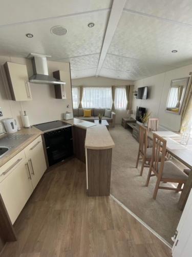 a kitchen and living room with a table and chairs at The Rannoch Len 1 in Forfar