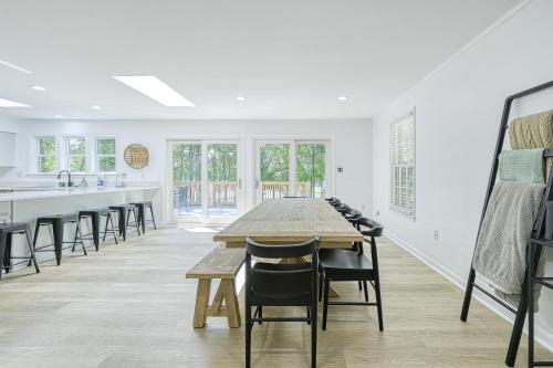 a white kitchen with a long table and chairs at Lake it to the Limit in Bumpass