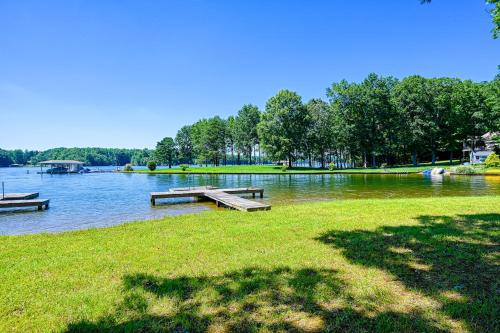 a park with benches and a lake with trees at Lake it to the Limit in Bumpass