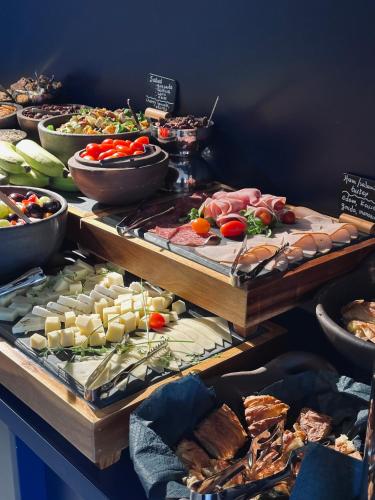 a buffet filled with lots of different types of food at The Newel Acropolis in Athens