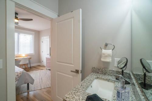 a bathroom with a sink and a mirror at Walk to Helen Downtown-Gated Golf Resort in Helen