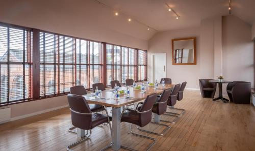 a conference room with a long table and chairs at Clifden Station House Hotel in Clifden