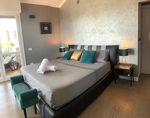 a bedroom with a large bed with a dog on it at Penthouse genneruxi in Cagliari