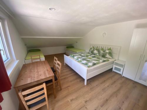 a small bedroom with a bed and a table at Auszeit Salzkammergut Appartements in Bad Ischl