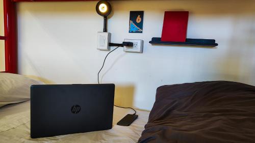 a laptop computer sitting on top of a bed at Antarctica Hostel in Ushuaia
