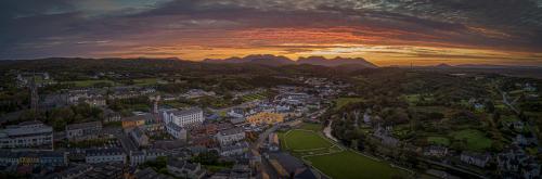 an aerial view of a city at sunset at Clifden Station House Hotel in Clifden