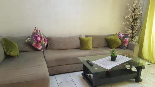 a living room with a couch and a table at Magic House Mansouria in Mansouria