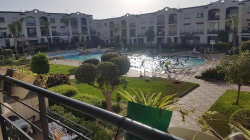 a view from the balcony of a apartment building with a swimming pool at Magic House Mansouria in Mansouria