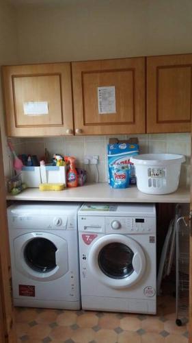 a kitchen with a washing machine and a washer at Three Sisters Holiday Home - 7km to Dingle in Ballyferriter