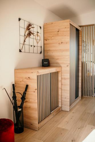 a room with a wooden wall and a shelf at JeLienka in Lietavská Závadka