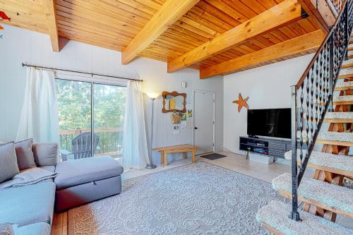 a living room with a couch and a television at Hidden Oasis - MCA #50602 in Manzanita