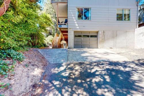 a house with a driveway leading to a garage at Hidden Oasis - MCA #50602 in Manzanita