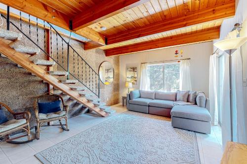 a living room with a couch and a staircase at Hidden Oasis - MCA #50602 in Manzanita