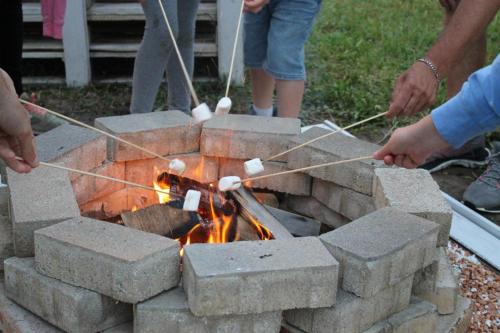 a group of people constructing a brick fire pit at Casa degli Ulivi in Tolentino