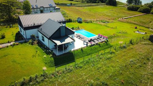 an aerial view of a house with a swimming pool at Dwa Żurawie - Głuszyn in Głuszyn