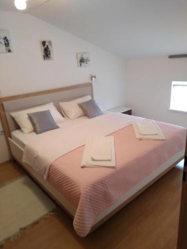 a bedroom with a large bed with two towels on it at Apartment Matulji in Matulji