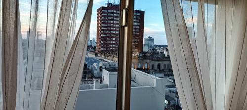 a window with a view of a city at Departamento Centrico Tandil in Tandil