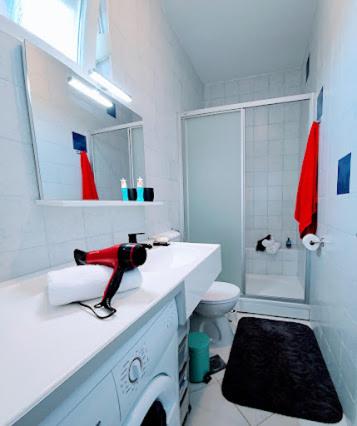 a white bathroom with a sink and a shower at Stella House Mrežnica in Duga Resa