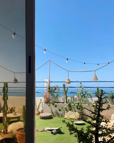 a view of a patio with a view of the ocean at Good Wave Surf House in Tamraght Oufella