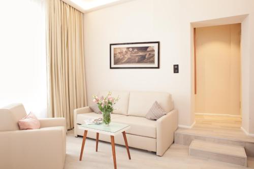 a living room with a couch and a table at Hotel Schweriner Hof in Stralsund