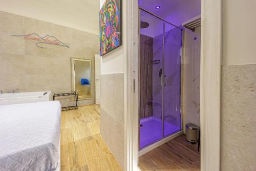 a bedroom with a shower with purple lighting at Live suite Napoli in Naples