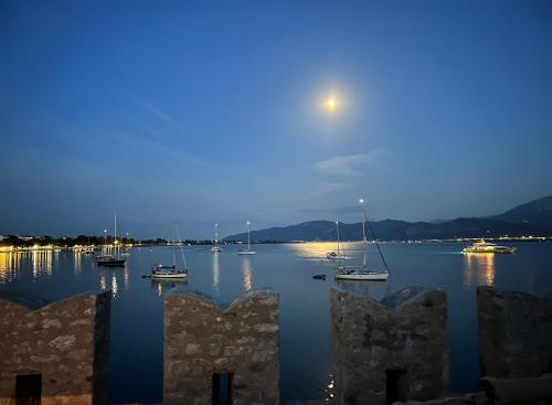 a view of a harbor with boats in the water at night at Madame Parisienne in Nafpaktos