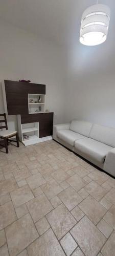 a living room with a couch and a tile floor at Casa Eoliana in Lipari