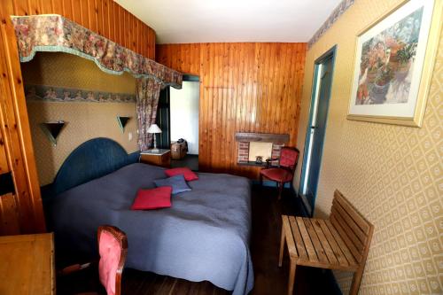 1 dormitorio con cama azul y almohadas rojas en Domaine "Le Ry d'Ave", en Rochefort