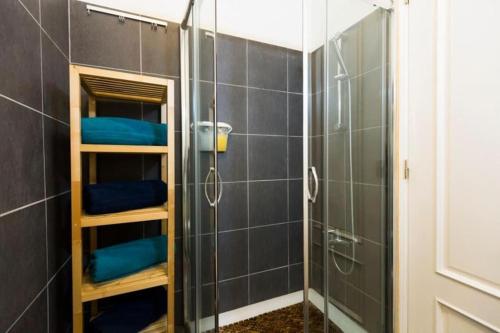 a bathroom with a shower with blue towels in it at Ola Lisbon - Chiado 1 in Lisbon