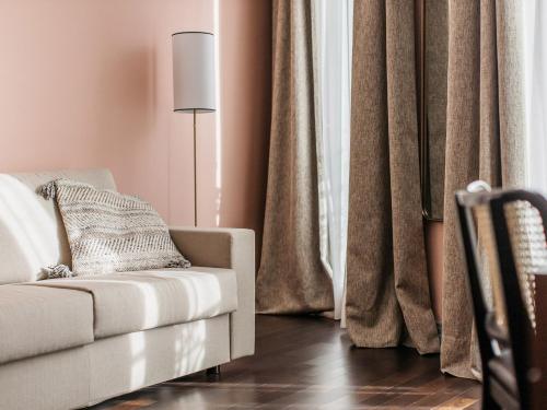 a living room with a couch and a lamp at New Hotel Le Quai - Vieux Port in Marseille