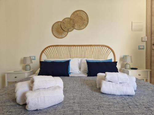 a bedroom with a large bed with towels on it at Posidonia B&B in Terrasini