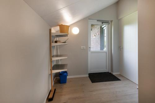an empty room with a door and a shelf at Bungalowpark Bij de Bronnen in Nutter