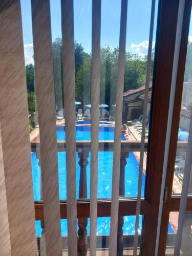 a view of a swimming pool from a balcony at Парк - Хотел Макензен in Melnik