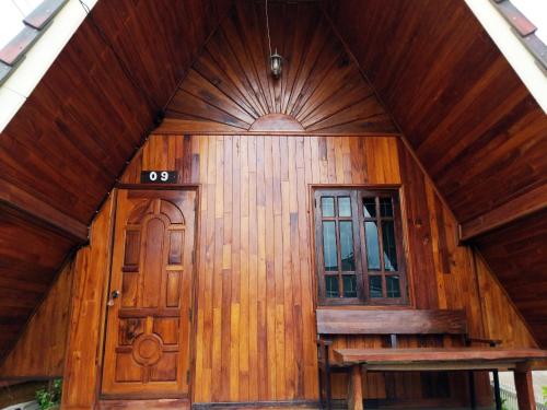a wooden house with a door and a window at Bansuanphuhong Resort in Chiang Khan