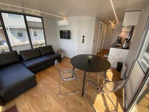 a living room with a black couch and a table at Ringö Resort in Gothenburg