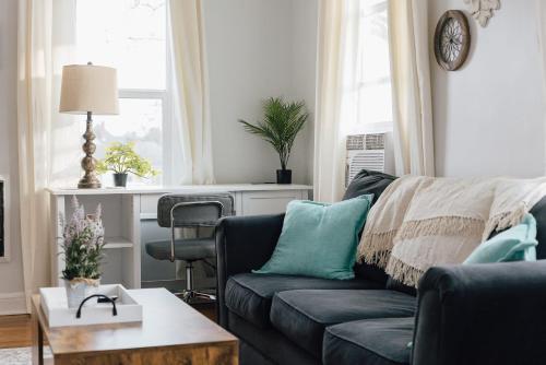 a living room with a couch and a table at Villa Chic near Downtown Bristol King Bed in Bristol