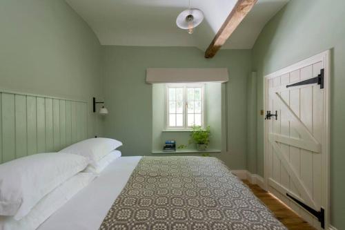 a bedroom with a white bed and a window at Glan Honddu Lodge in Brecon